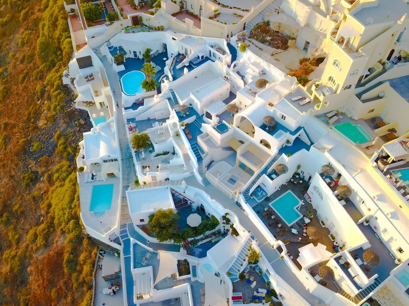 The white houses and blue pools of the village, seen from above
