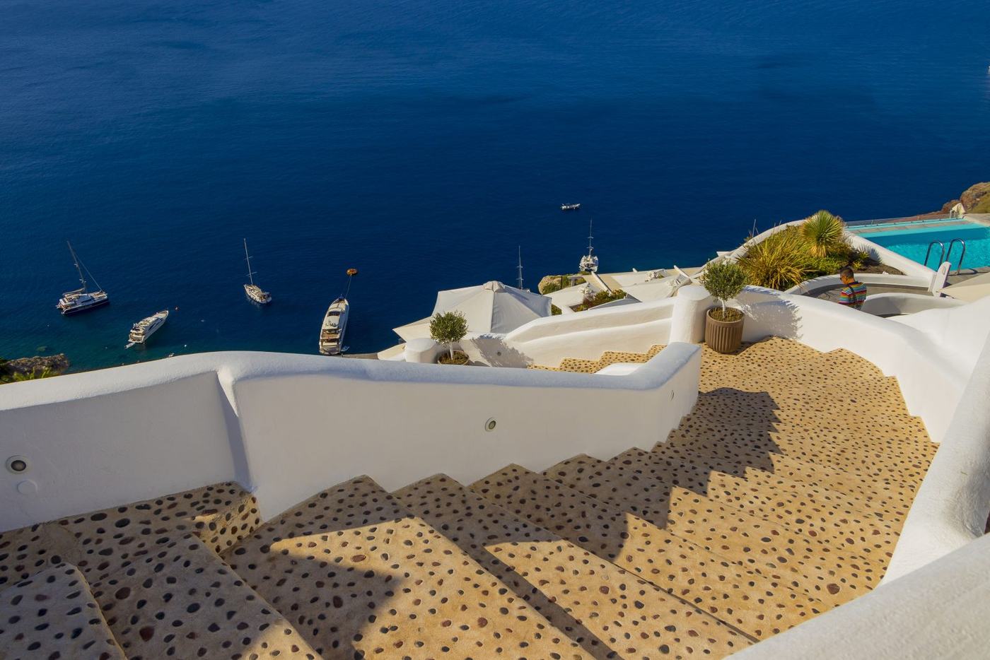 A terrace above the sea, boats in the bay